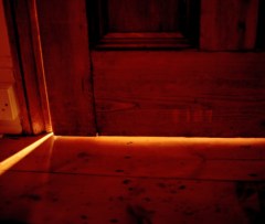 Slightly open door, light shining through crack